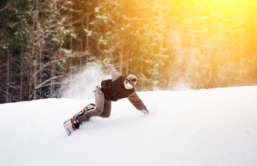 Snowboarder,rides,over,fresh,snow,on,the,slope,in,winter,